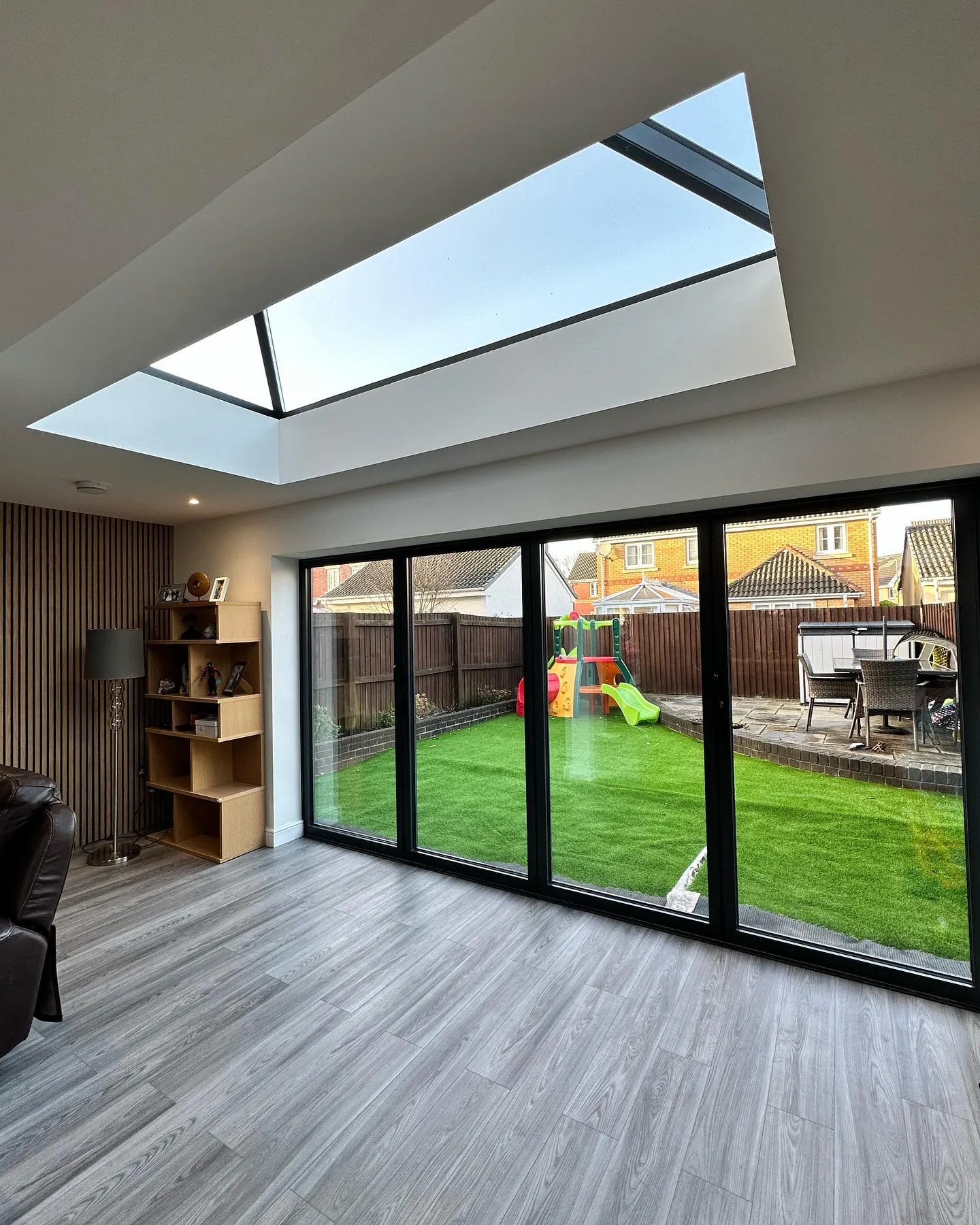 A living room filled with furniture and a skylight.
