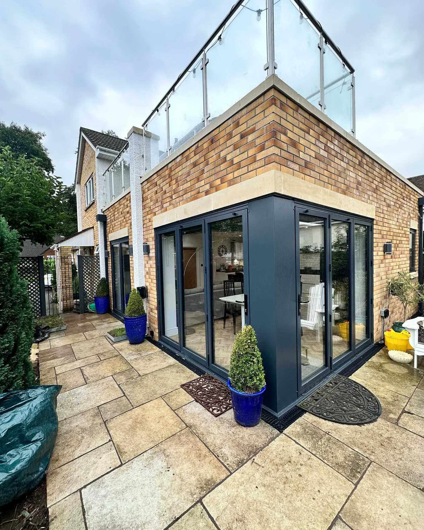A house with a glass roof and a patio.