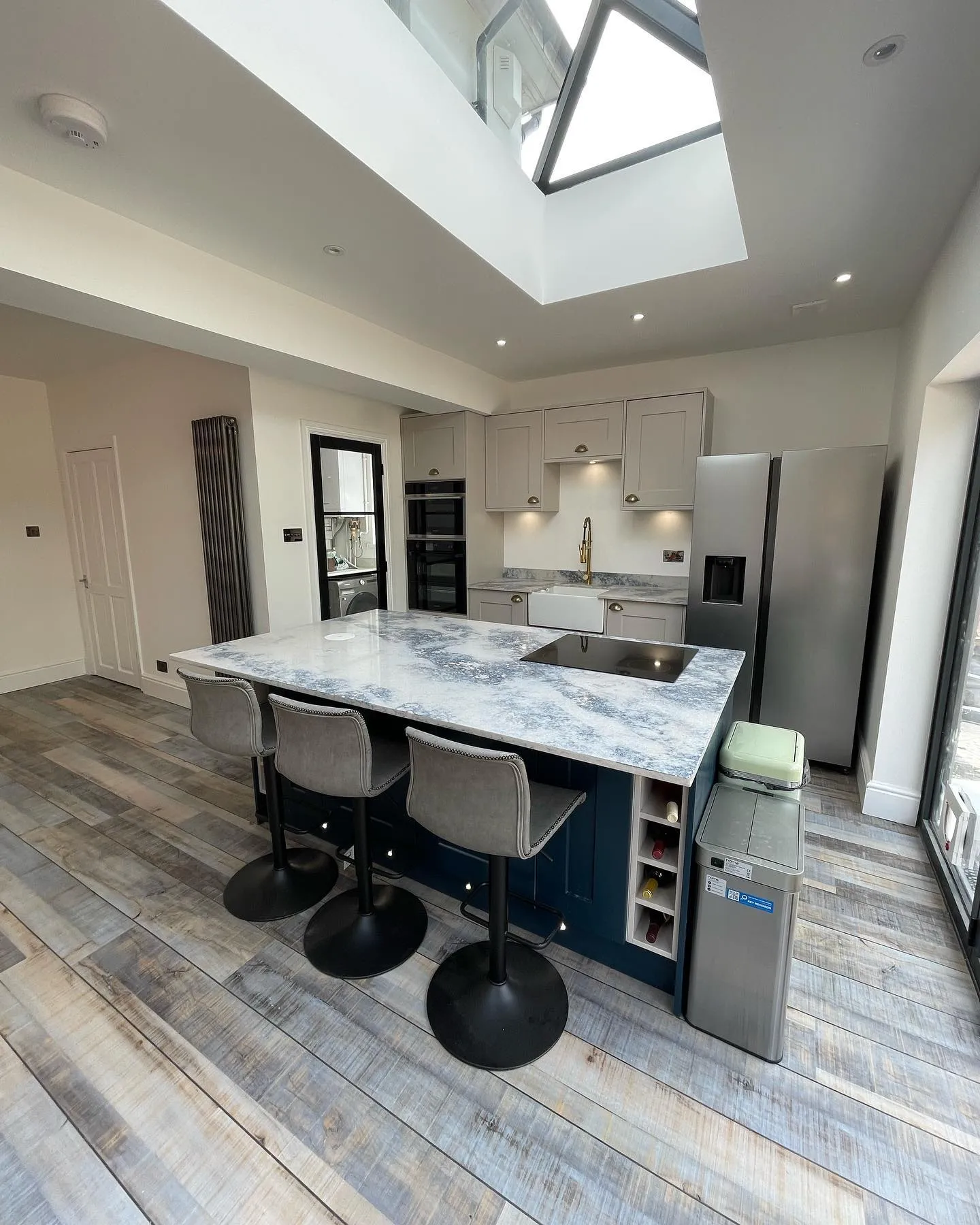 A kitchen with a center island and a skylight.