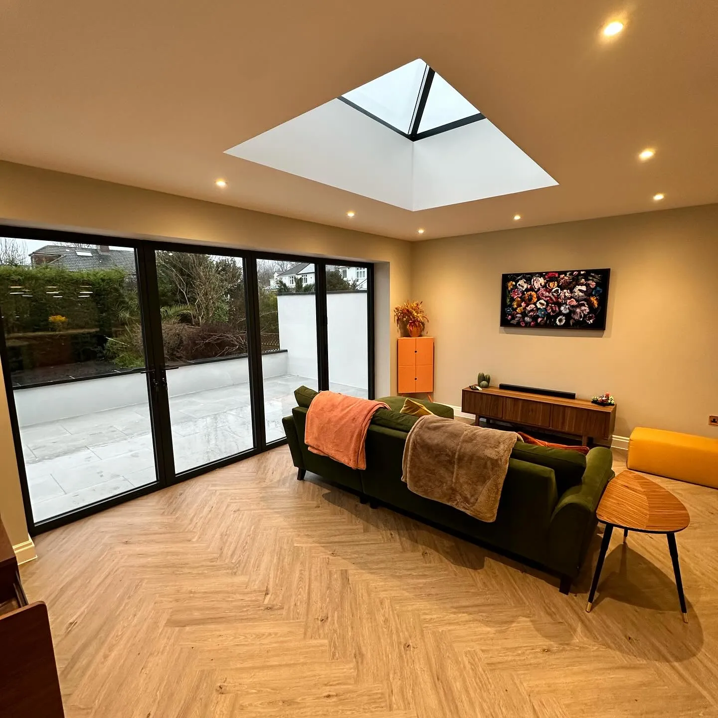 A living room filled with furniture and a skylight.