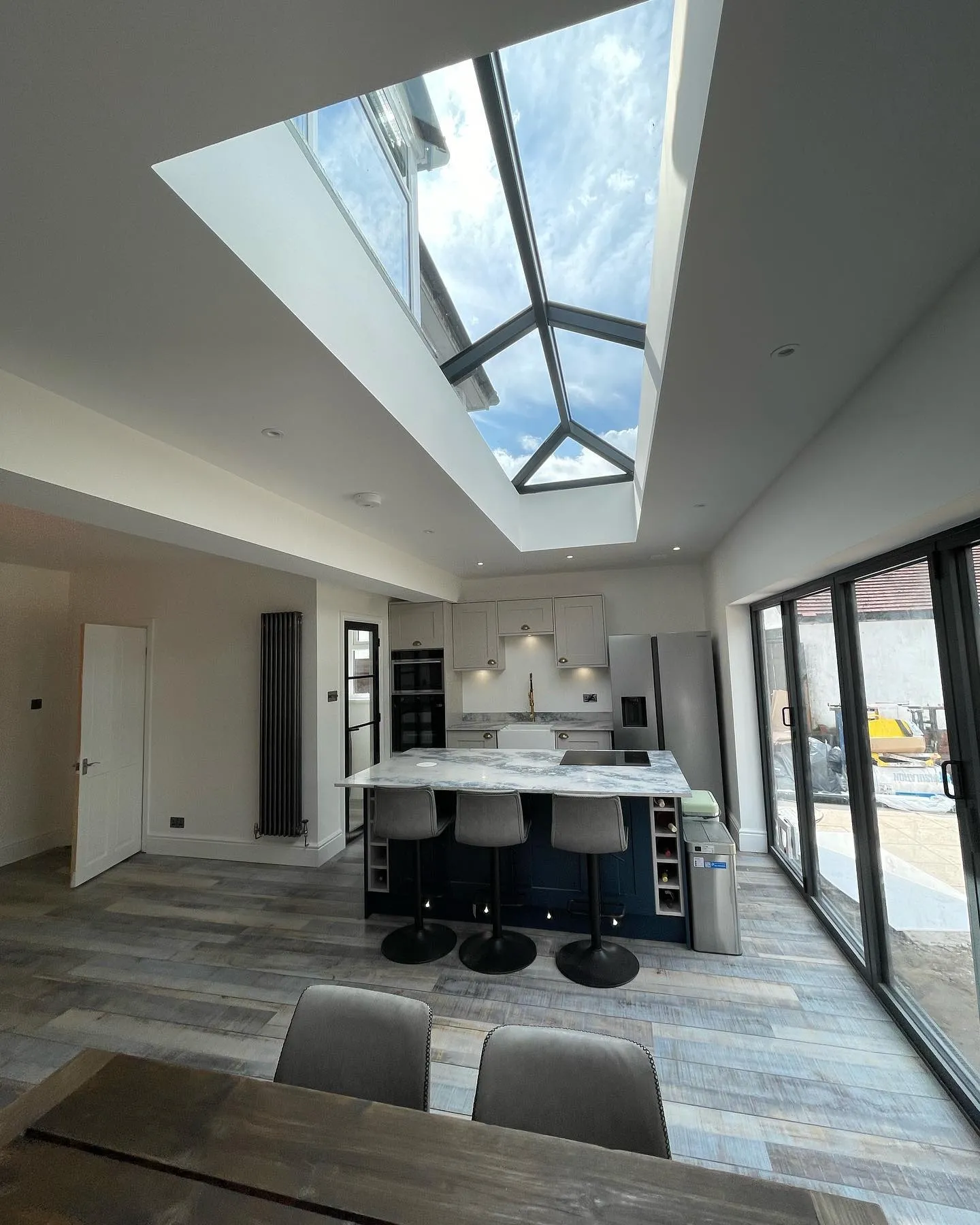 A kitchen with a skylight above the island.