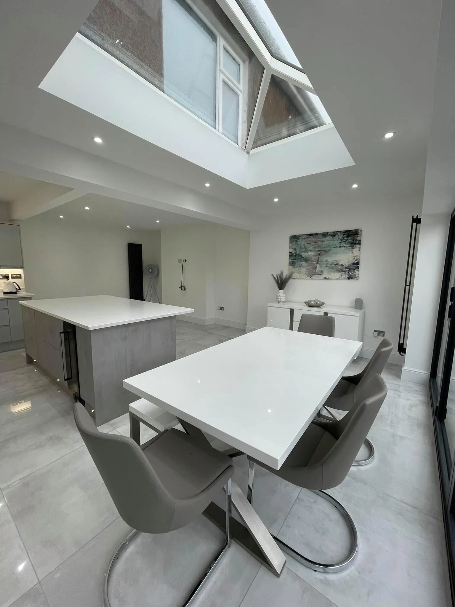 A white table and chairs in a room.