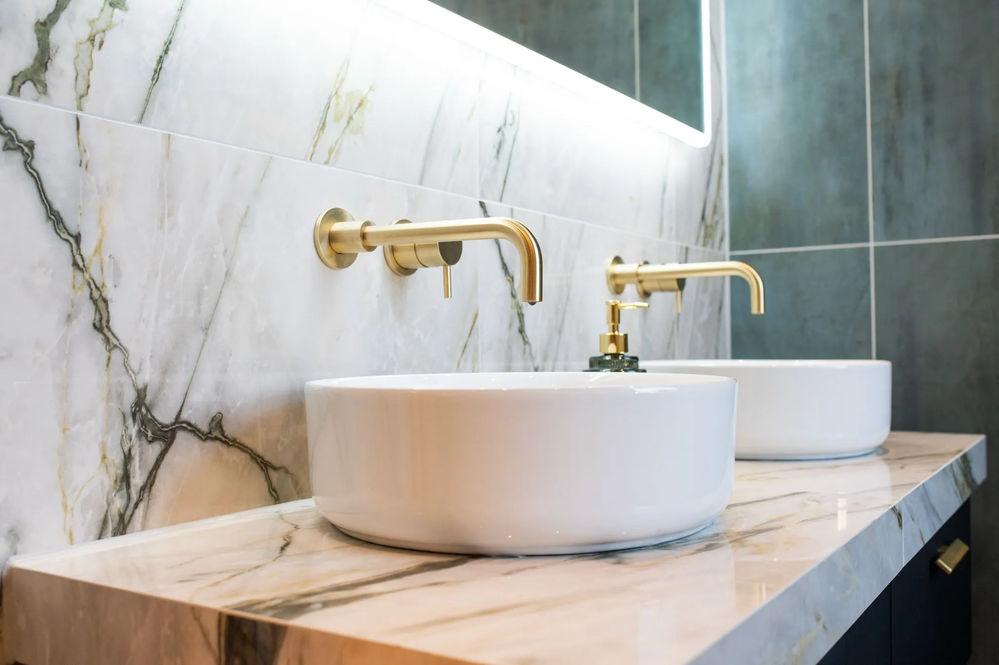 Bathroom sink with gold tap