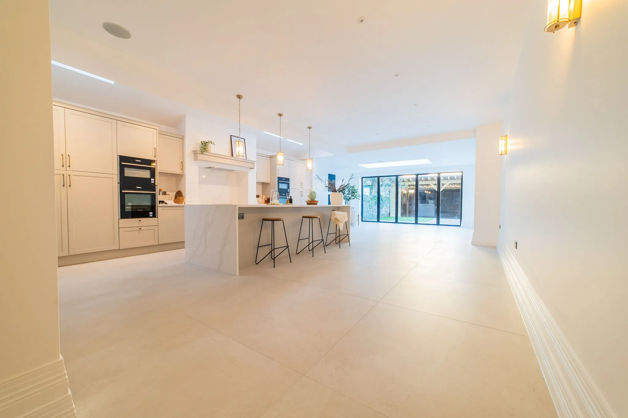 large kitchen angle showing island with stools